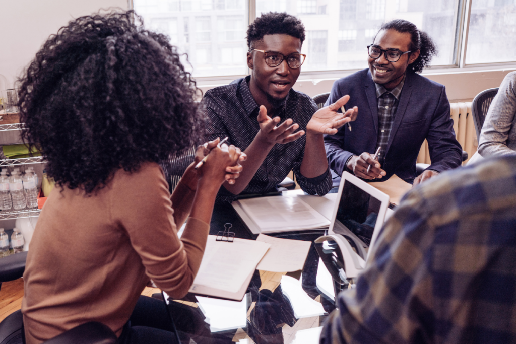 coworkers talking around a large table